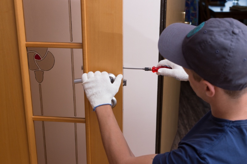 man-fixing-door-with-screwdriver-close-up-photo