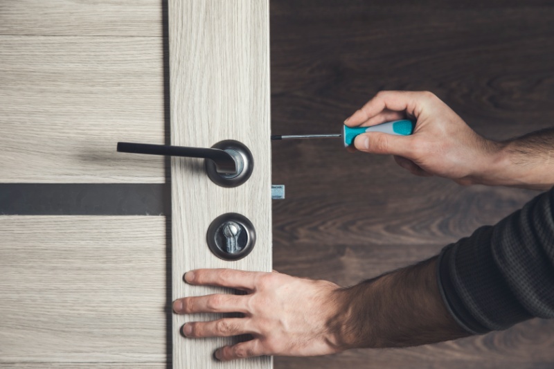 man-is-installing-part-wooden-door-by-screwdriver