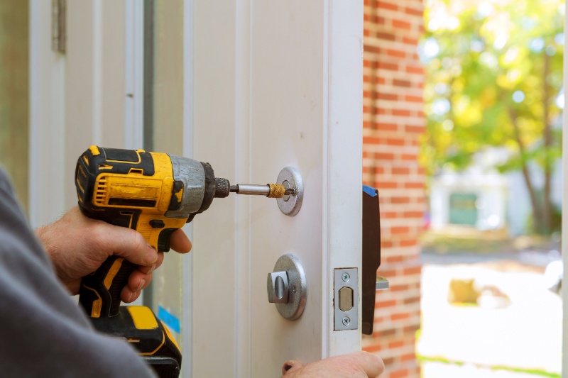 man-repairing-doorknob-closeup-worker-s-hands-installing-new-door-locker
